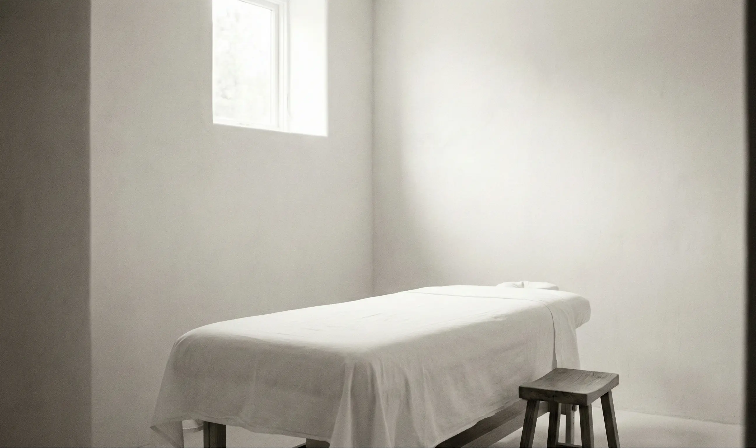 A quiet, minimal treatment room with natural light